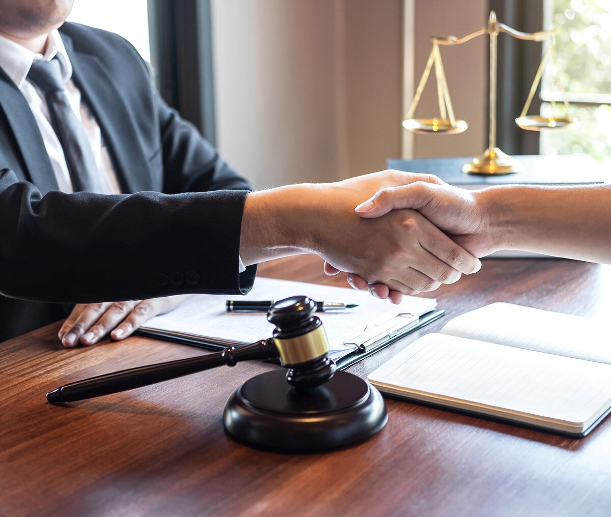 Lawyer's desk with handshake